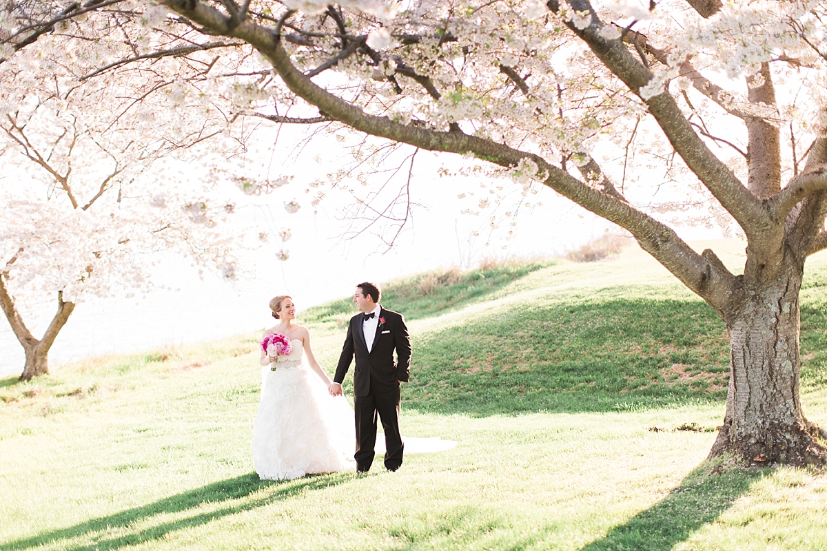 A stunning black tie spring wedding full of stunning pink cherry blossom flowers at Kingsmill Resort on the James River in Williamsburg, VA. 