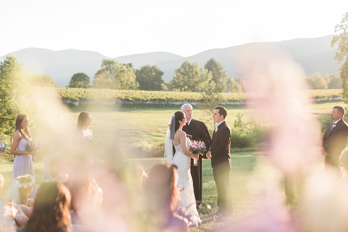 A classic winery wedding at Veritas Vineyards in Charlottesville, Virginia featuring a soft color palette of blue and purple with a stunning sunset ceremony. 