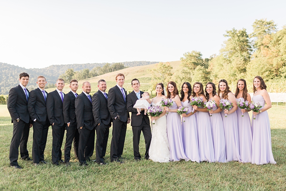 A classic winery wedding at Veritas Vineyards in Charlottesville, Virginia featuring a soft color palette of blue and purple with a stunning sunset ceremony.