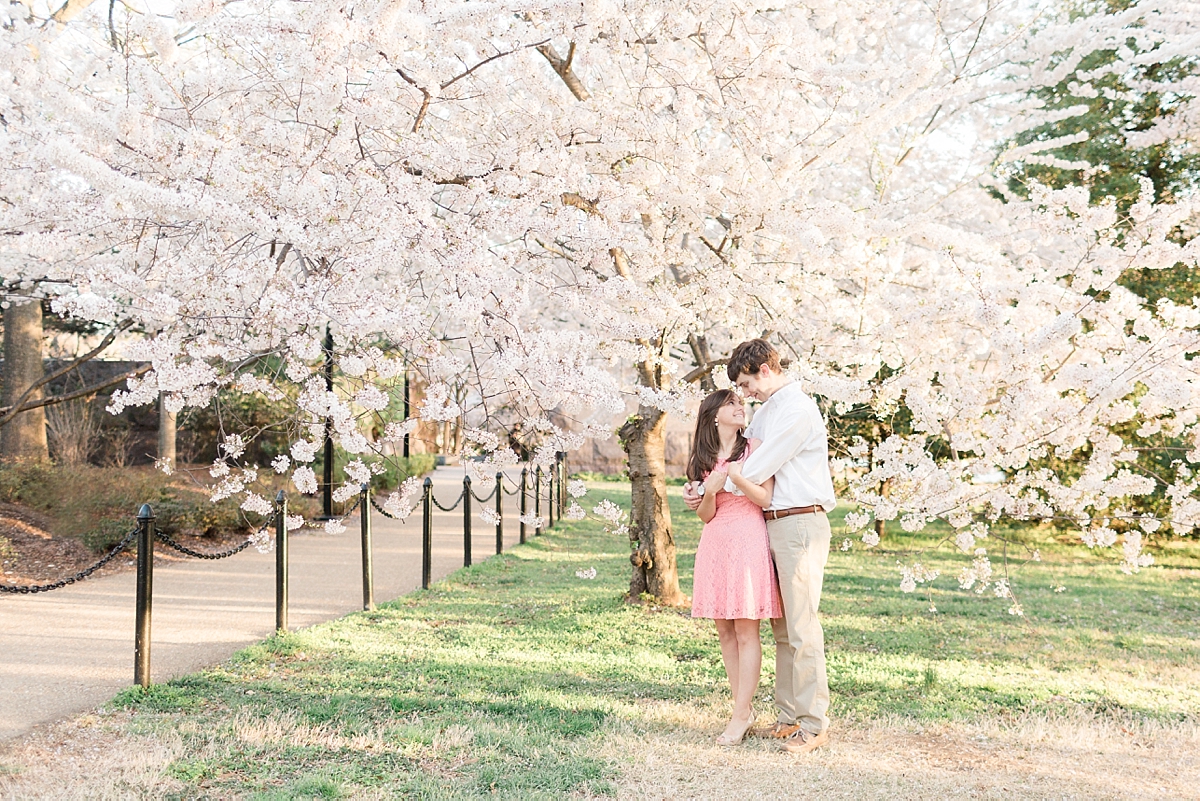 A romantic cherry blossom anniversary session photographed in Washington, DC along the Tidal Basin near the Jefferson Memorial on a beautiful spring day.