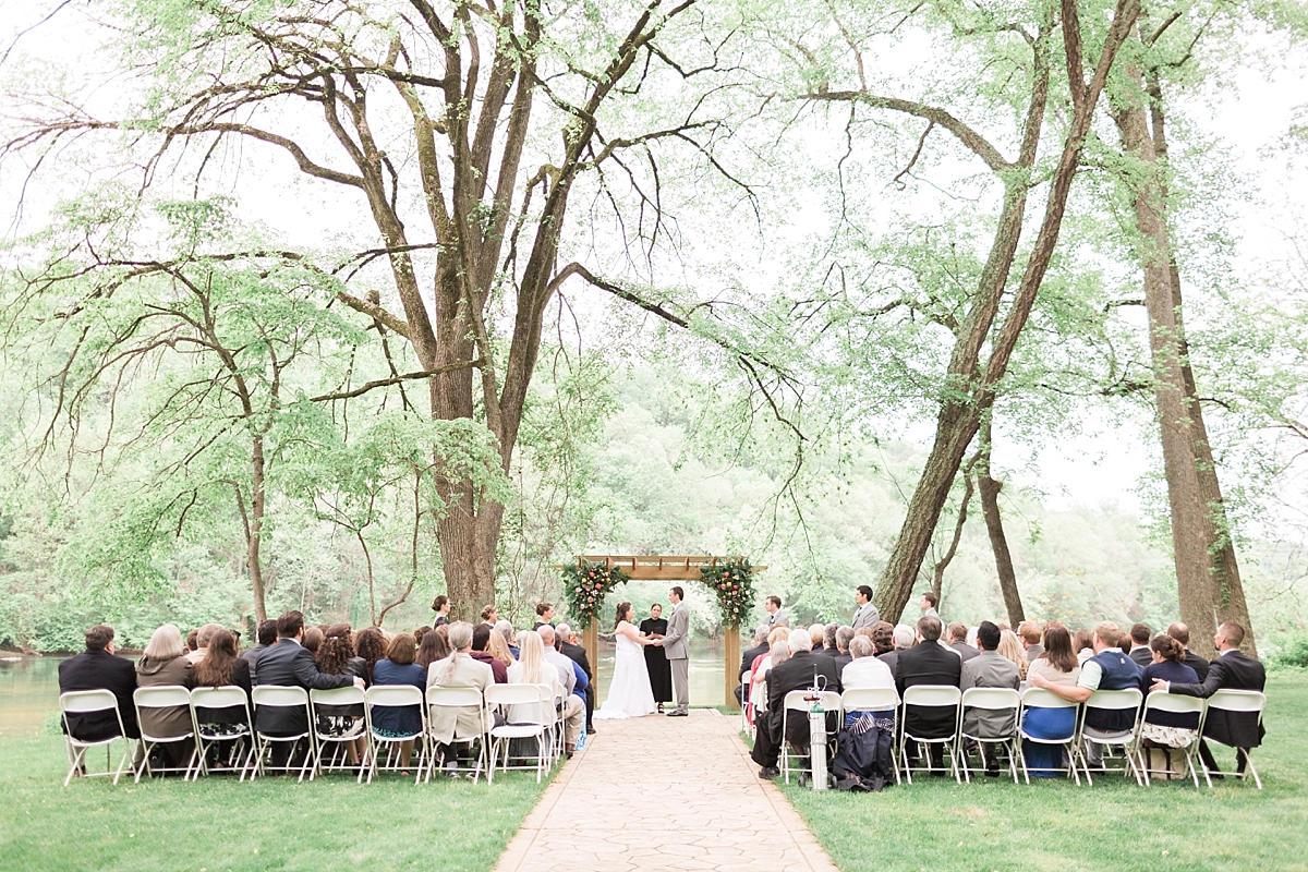 A stunning waterfront wedding surrounded by the natural beauty of Virginia's lush greenery and colorful flowers.