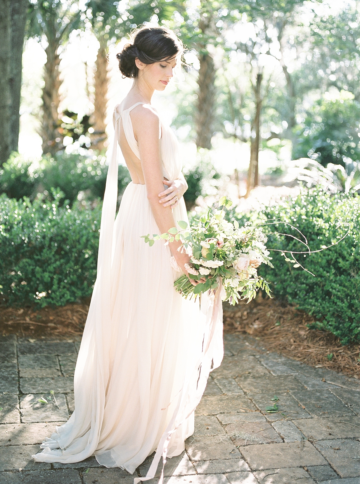 A gorgeous wedding at the waterfront venue of RiverOaks in Charleston, SC with a stunning muted palette highlighted by an abundance of flowers & Spanish moss.