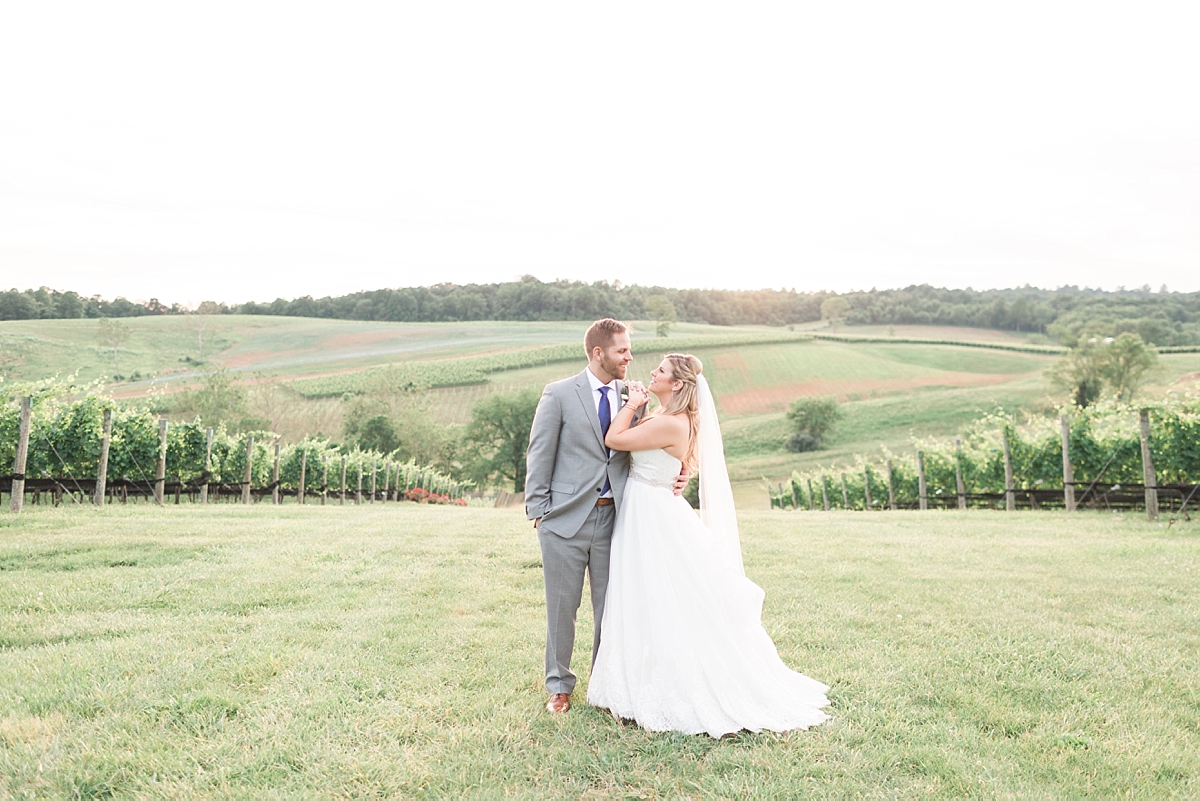 A gorgeous vineyard wedding photographed at Stone Tower Winery in Leesburg, VA filled with pops of colorful summer flowers.