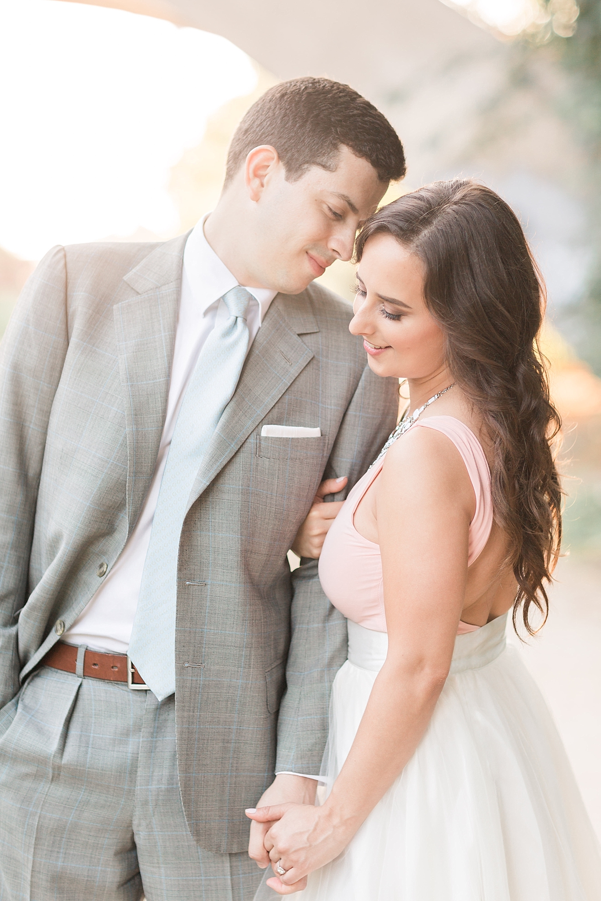 A stylish couple enjoys a sunrise engagement session along the iconic canals of Georgetown in Washington, DC; complete with a tulle skirt and Louboutin heels.