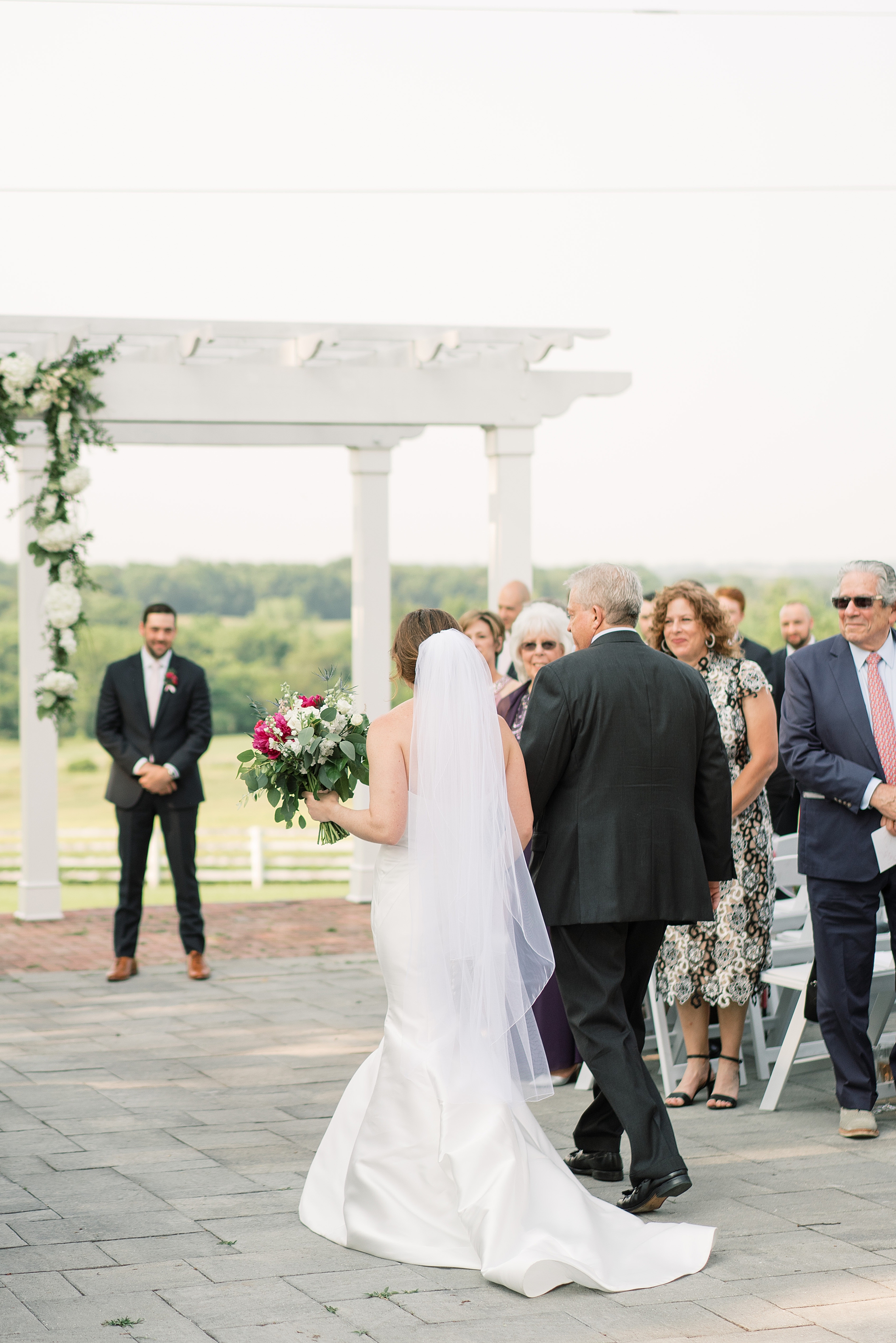 A summer wedding at Raspberry Plain Manor in Leesburg, VA featuring a cream and gold color palette with pops of greenery.