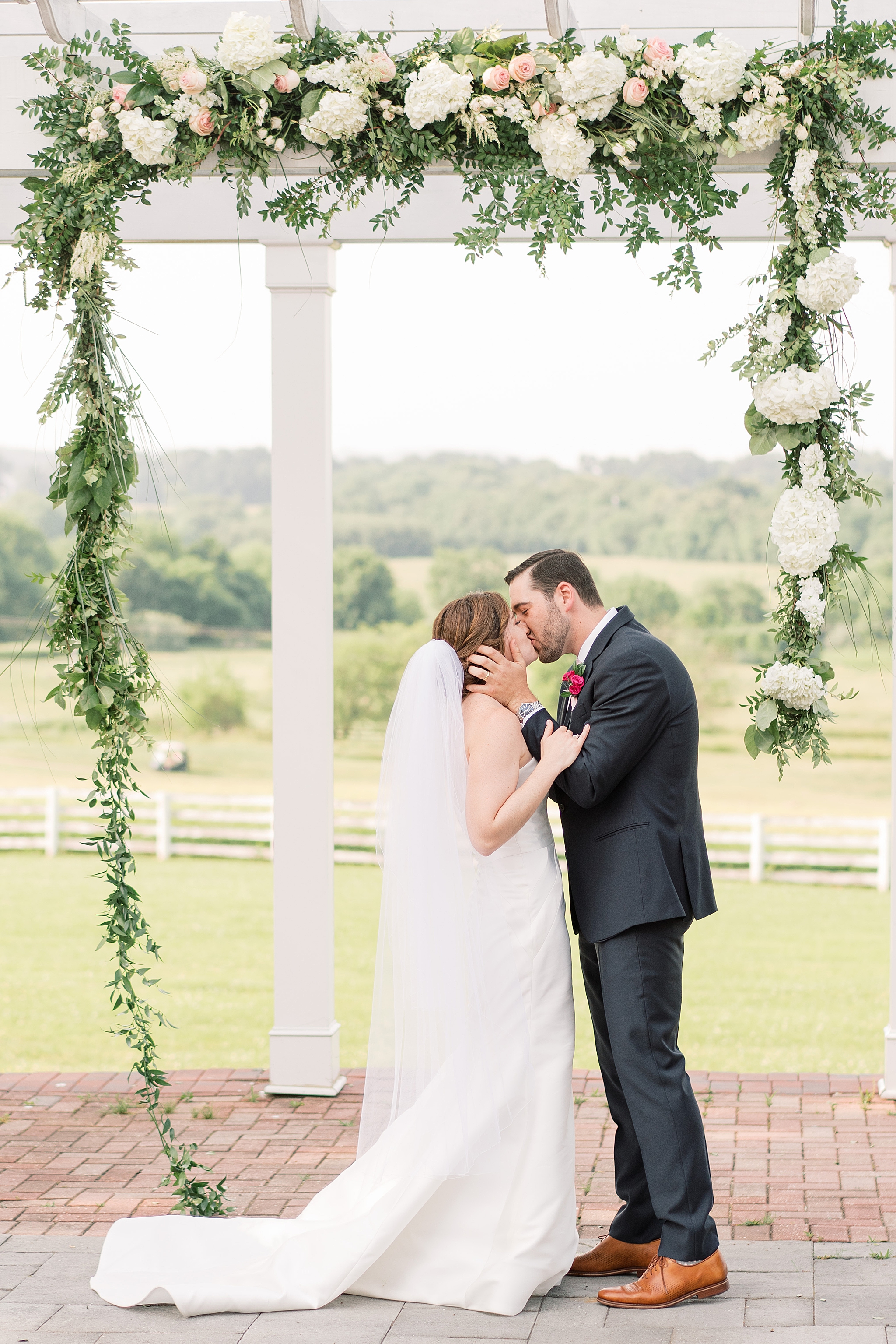 A summer wedding at Raspberry Plain Manor in Leesburg, VA  featuring a cream and gold color palette with pops of greenery. 