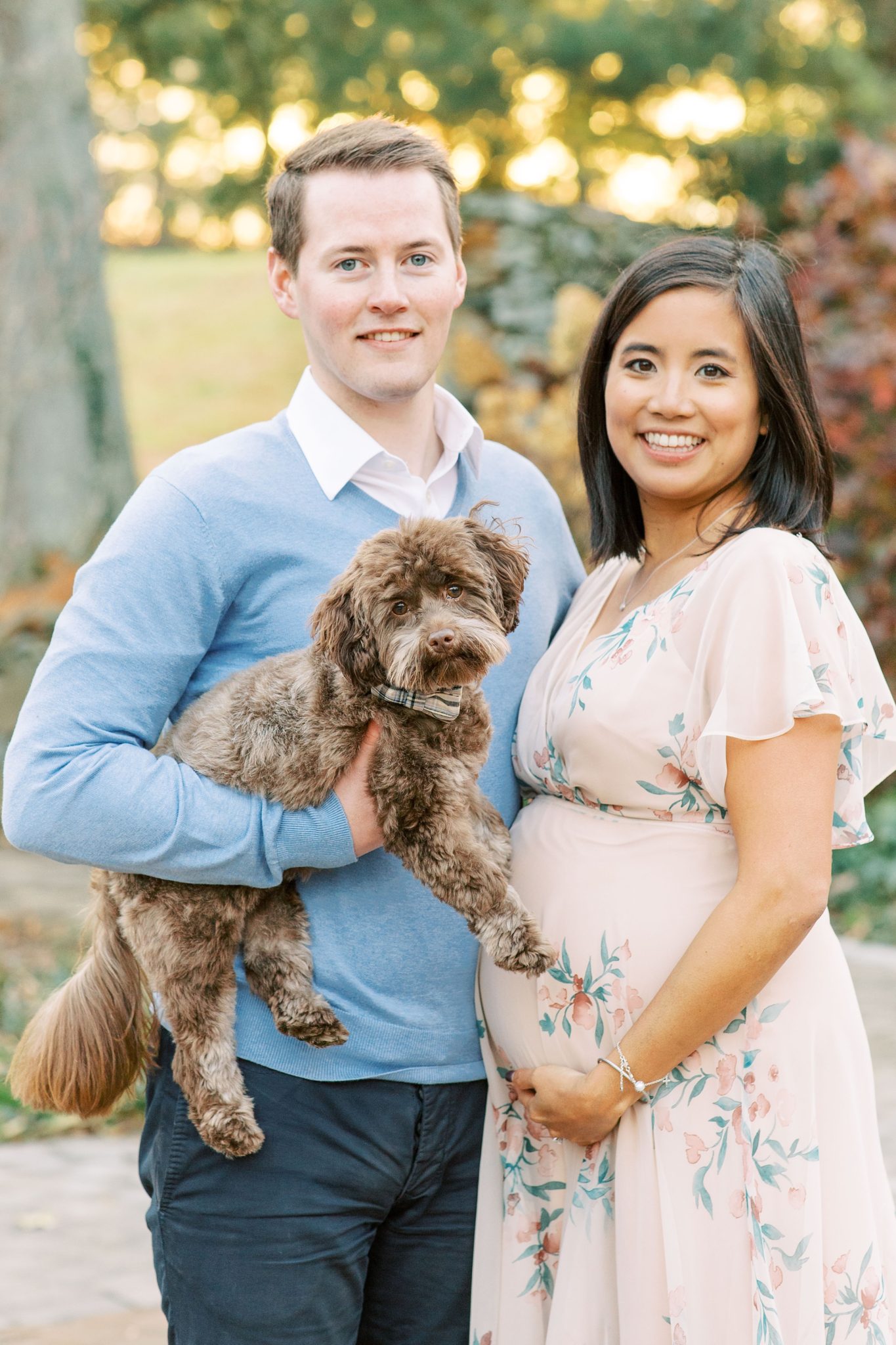 A fine art maternity session in the gardens of Airlie Center in Northern, VA featuring a stylish couple and their adorable dog.