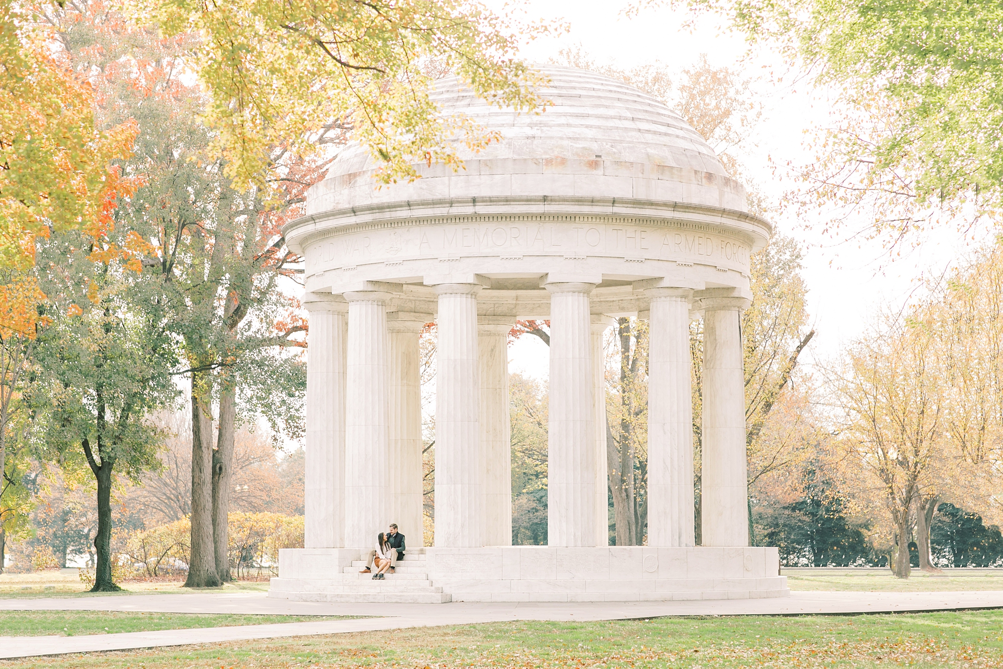 A romantic set of fall engagement photos taken at iconic DC monuments including the Lincoln Memorial and the DC War Memorial.