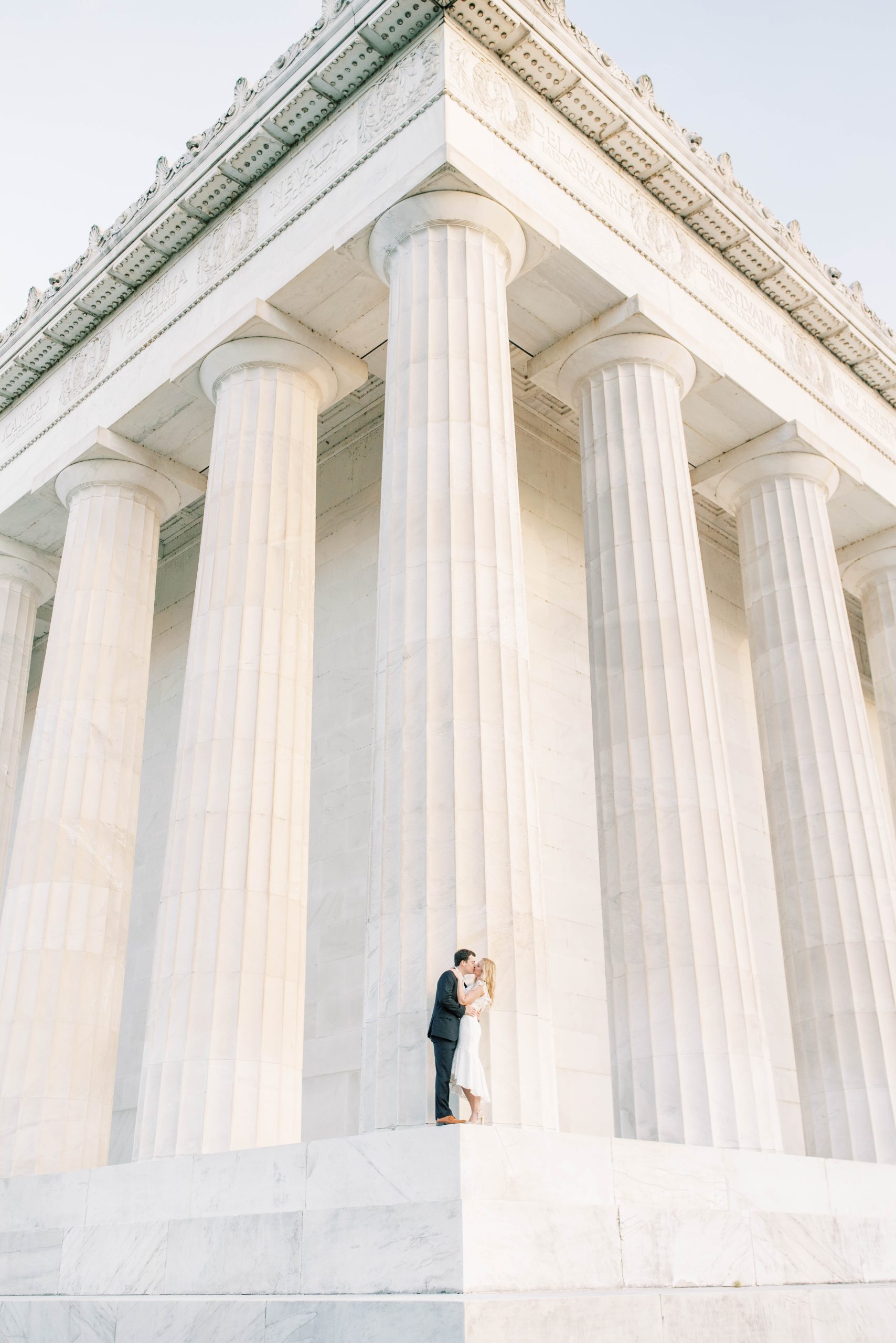 A stunning sunrise engagement session at the iconic monuments in Washington, DC featuring a stylish couple alongside their adorable dog!