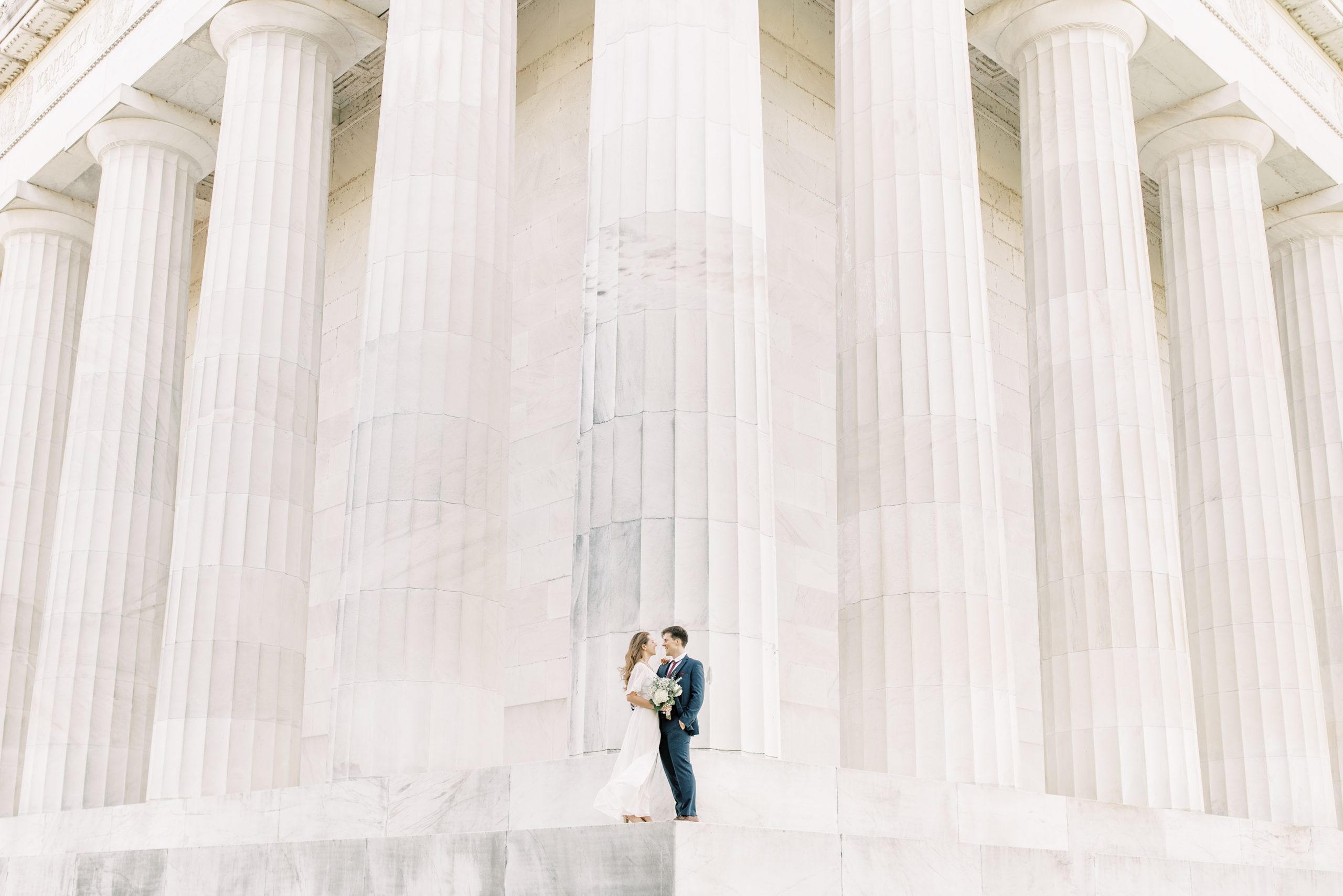 An intimate fall elopement at the DC War Memorial in Washington, DC with newlywed portraits following at the Lincoln Memorial.