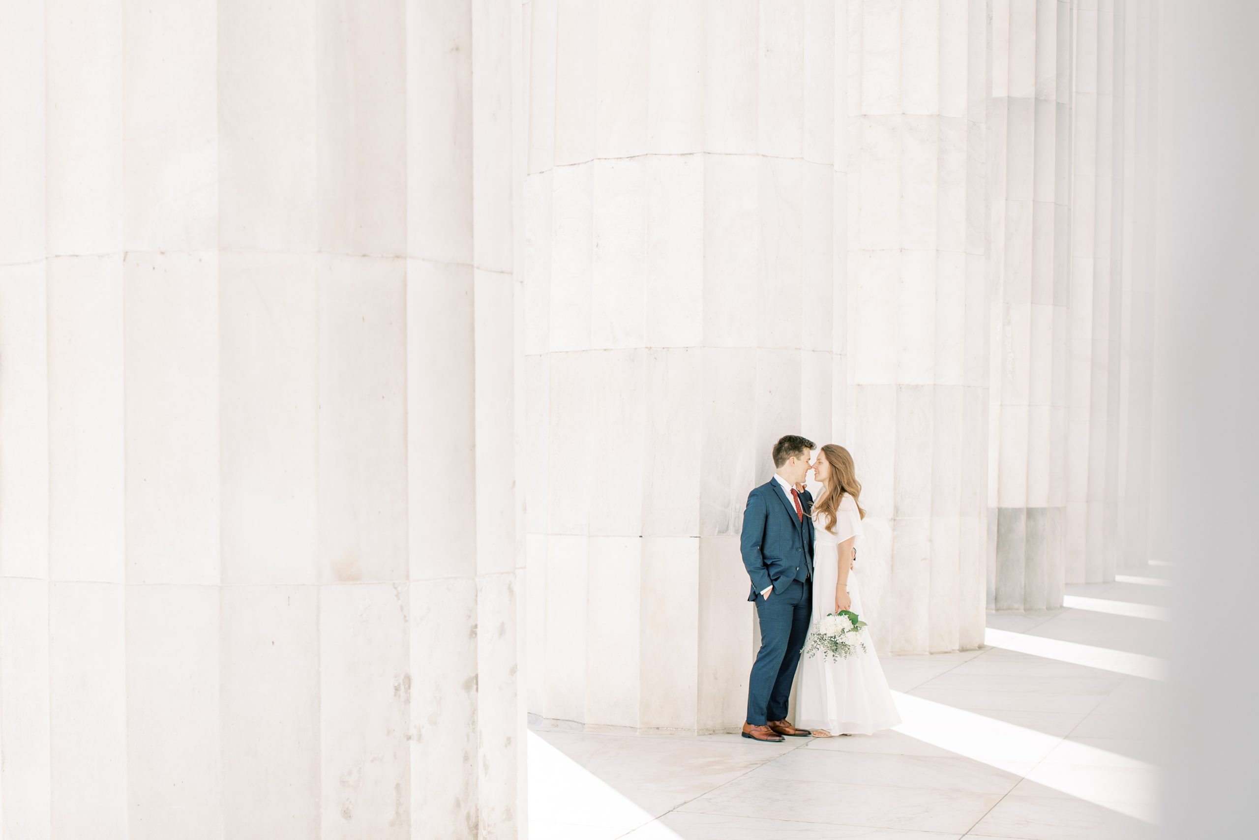 An intimate fall elopement at the DC War Memorial in Washington, DC with newlywed portraits following at the Lincoln Memorial.