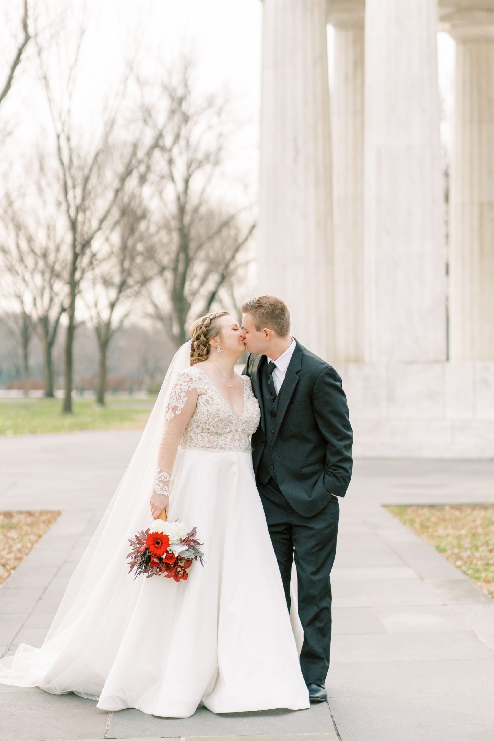 A wintery wedding elopement at the DC War Memorial in Washington, DC with portraits at the Lincoln Memorial and Washington Monument.