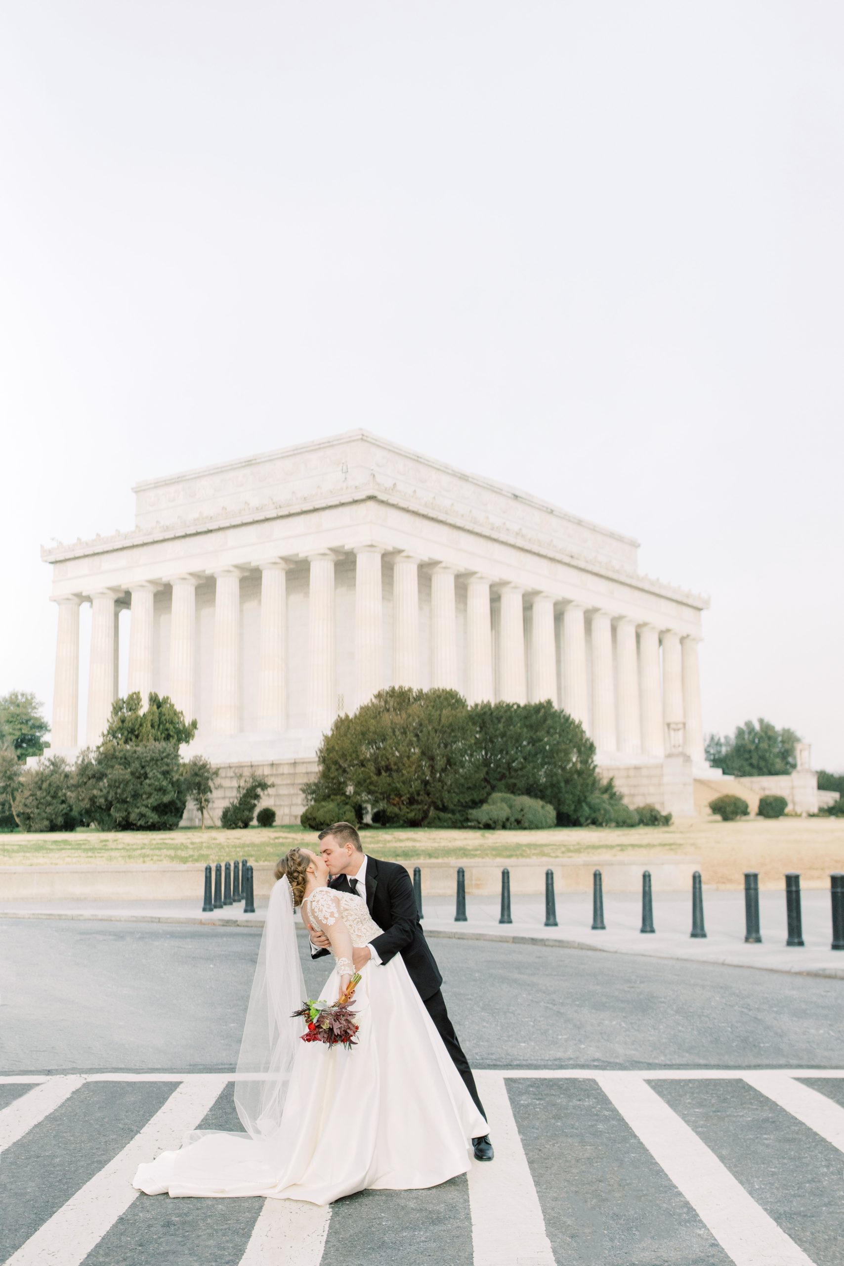 A wintery wedding elopement at the DC War Memorial in Washington, DC with portraits at the Lincoln Memorial and Washington Monument. 