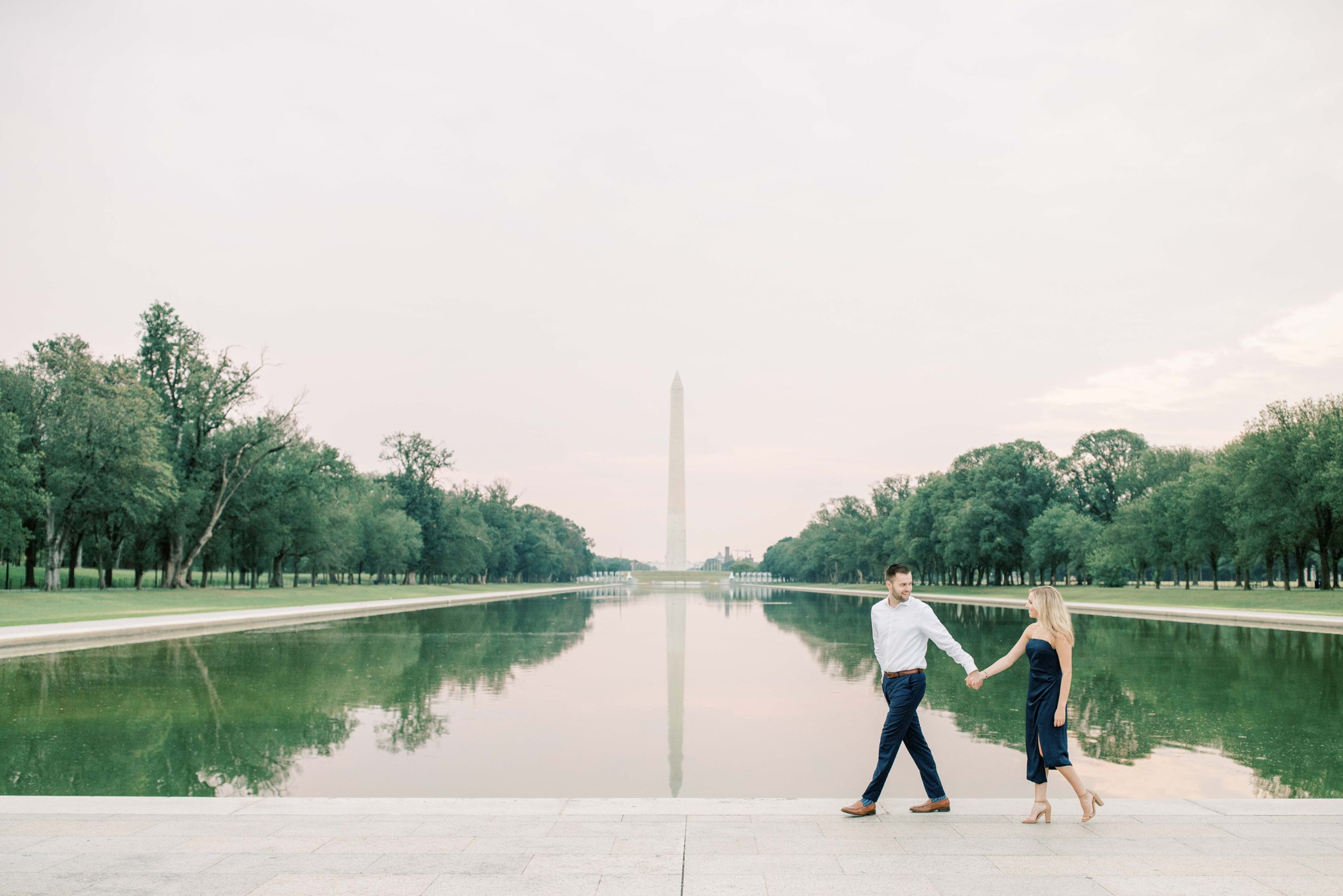 A stunning sunrise engagement session at the iconic monuments in Washington, DC including the Lincoln Memorial and DC War Memorial.