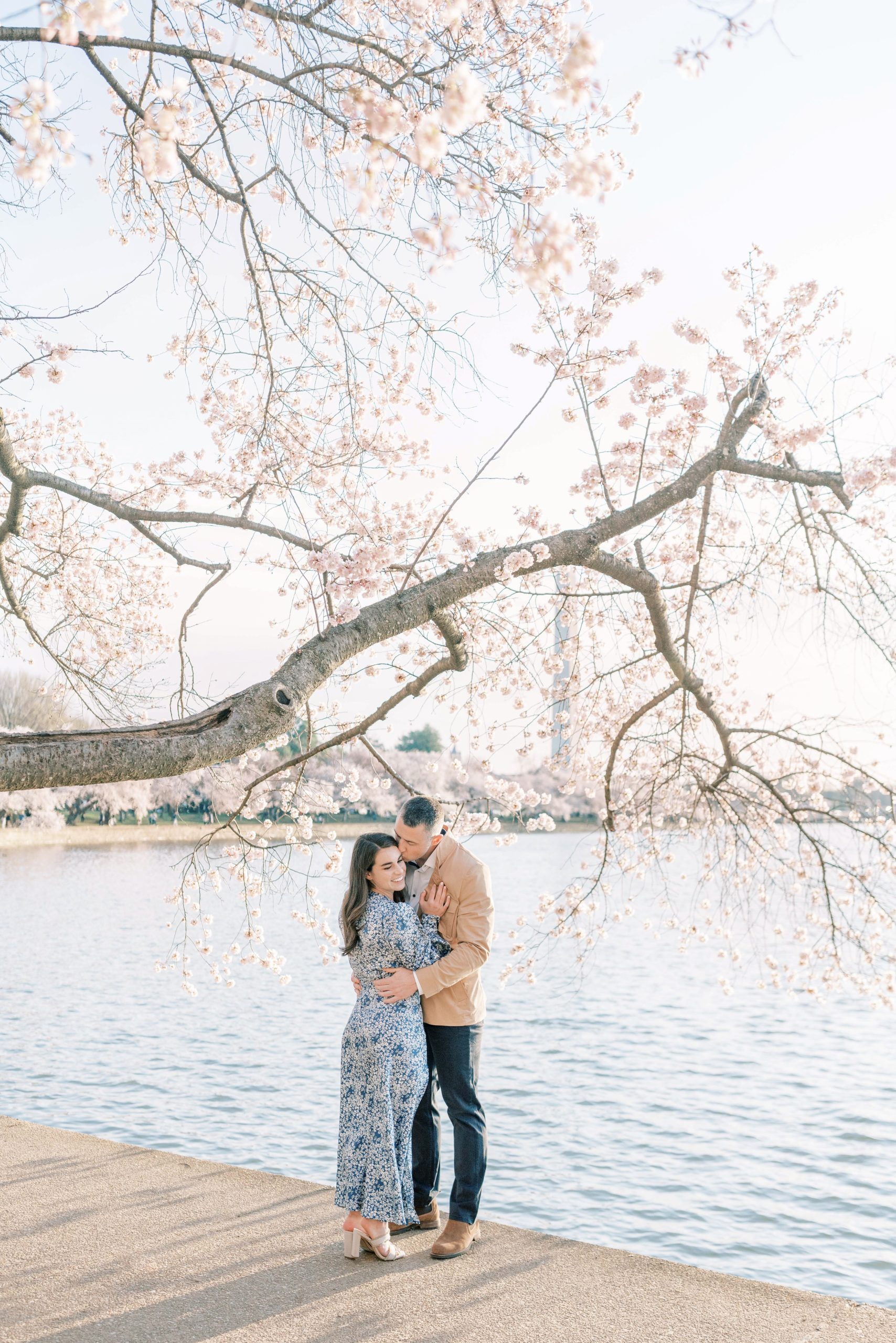 An iconic cherry blossom engagement session at the Tidal Basin of the Jefferson Memorial in Washington, DC during peak bloom!