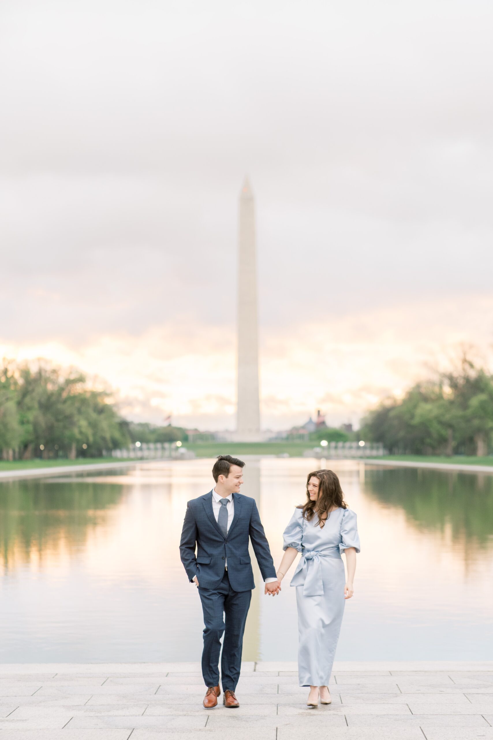 A romantic overcast engagement session at the Reflecting Pool & DC War Memorial on the National Mall in Washington, DC.