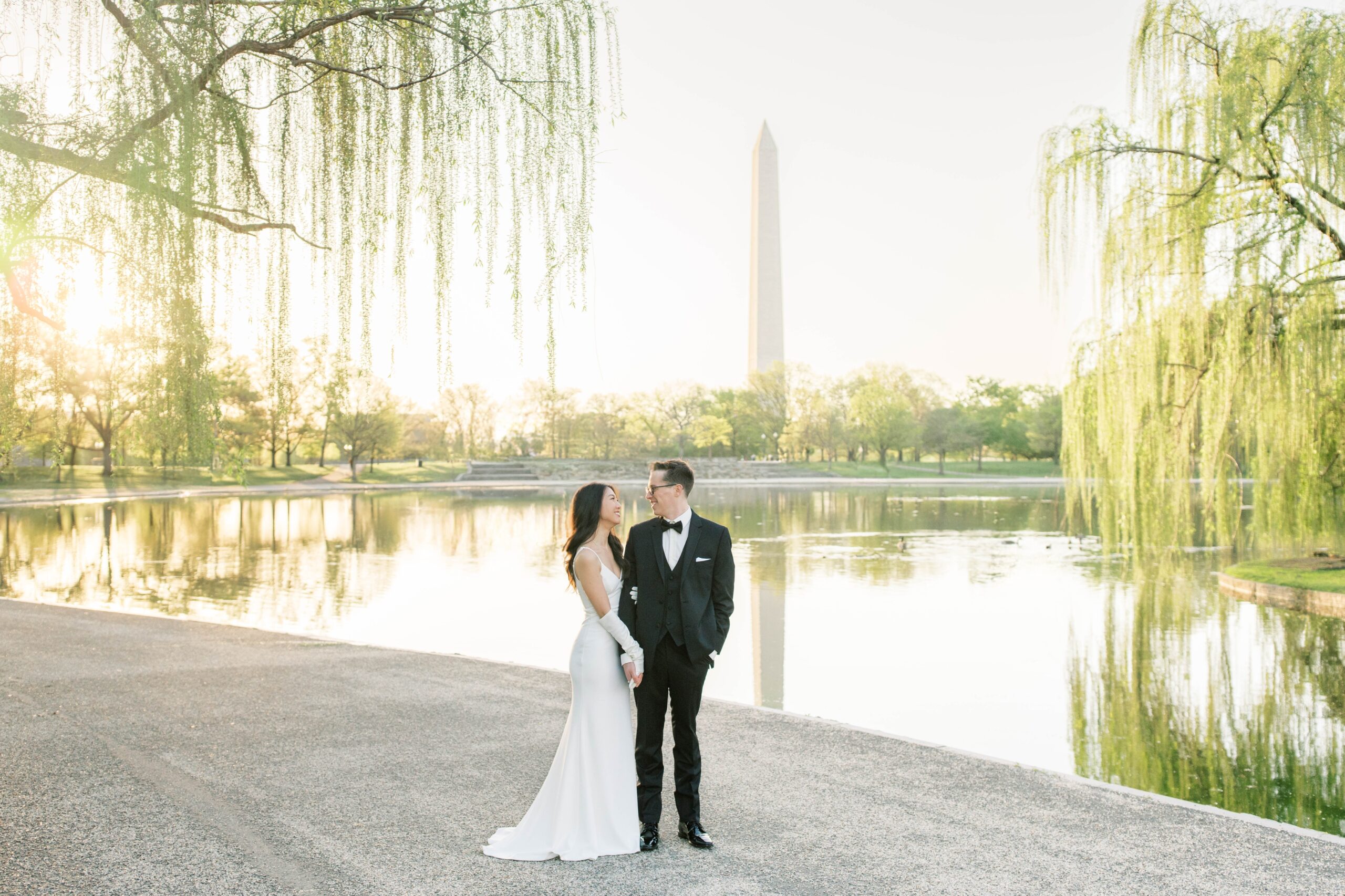 A beautiful sunrise elopement at the Reflecting Pool, Constitution Gardens, and DC War Memorial in Washington, DC.