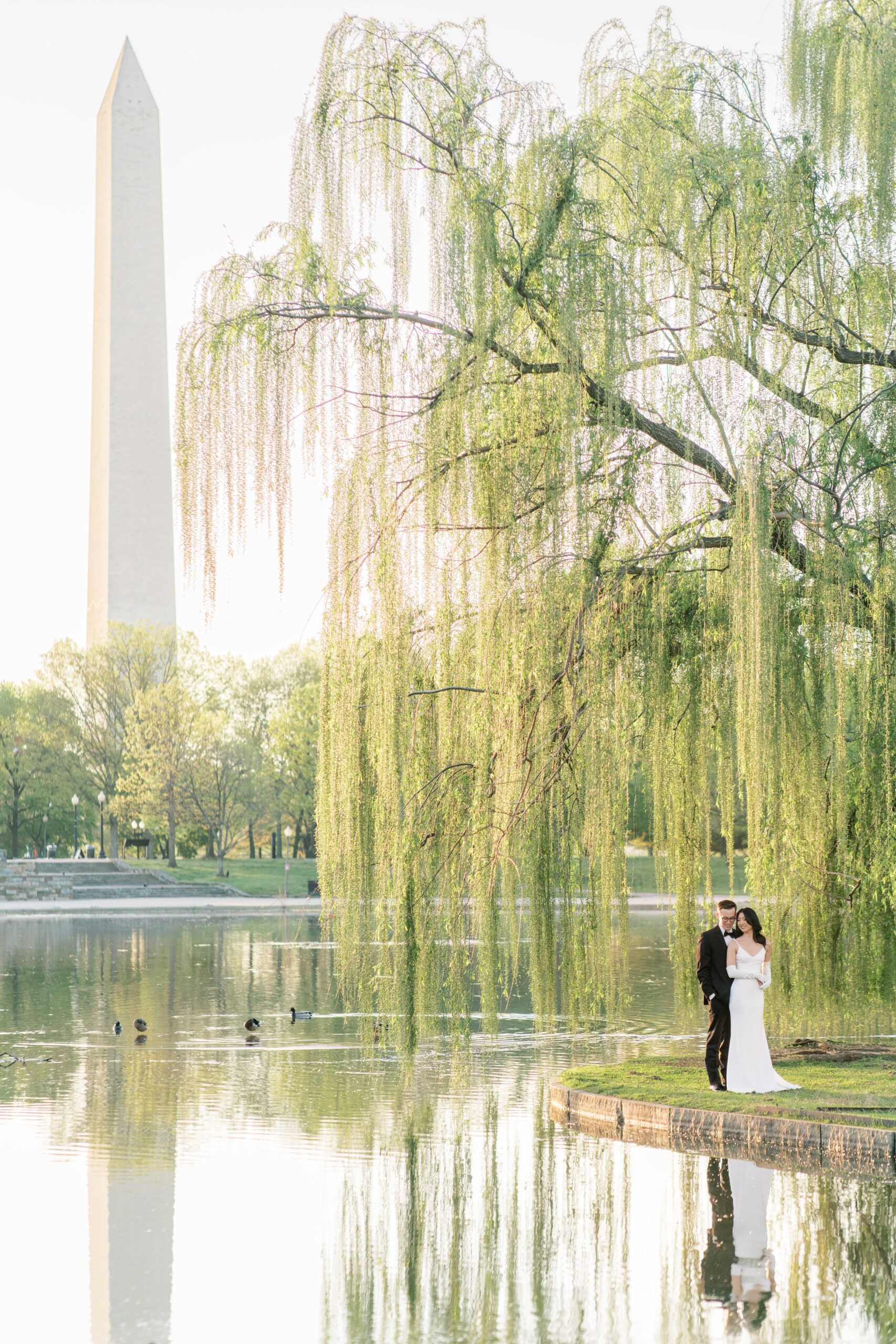 A beautiful sunrise elopement at the Reflecting Pool, Constitution Gardens, and DC War Memorial in Washington, DC.