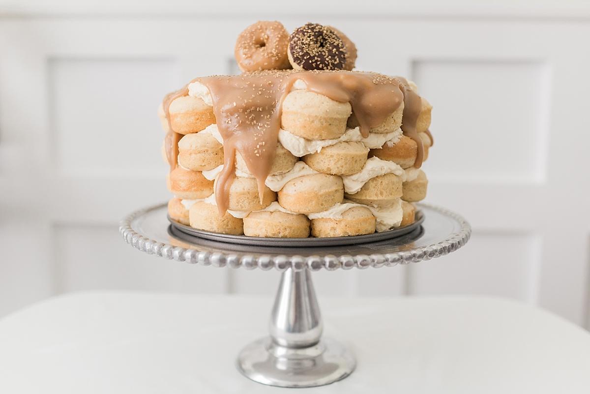A photographer who shoot weddings in Washington, DC also loves to bake! She tries her hand a her own recipe -- a caramel layered donut cake with whipped icing.