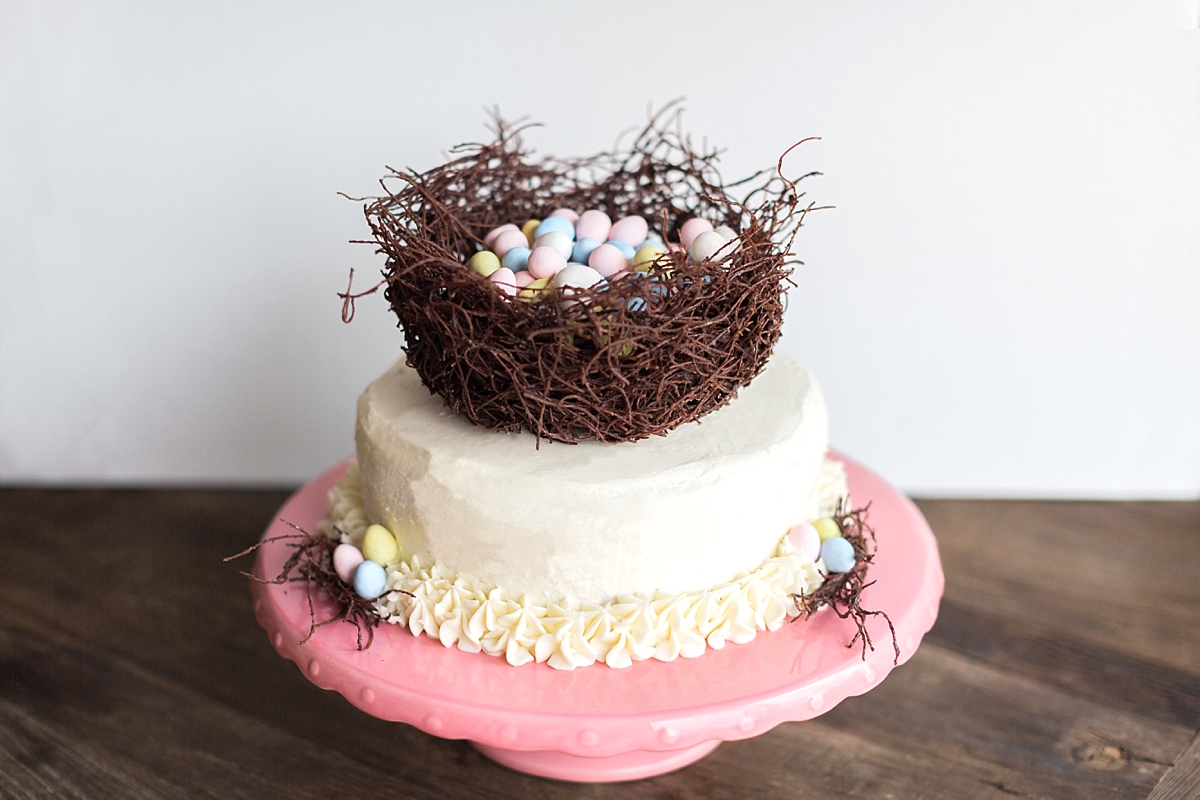 A beautiful spring Easter cake designed by Washington, DC wedding photographer, Alicia Lacey, features an edible bird's nest filled with colorful eggs.